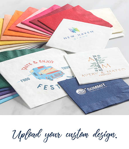 A stack of colorful napkins is fanned out with custom digital and foil stamped designs on top
