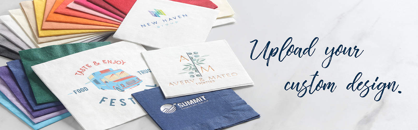 A stack of colorful napkins is fanned out with custom digital and foil stamped designs on top