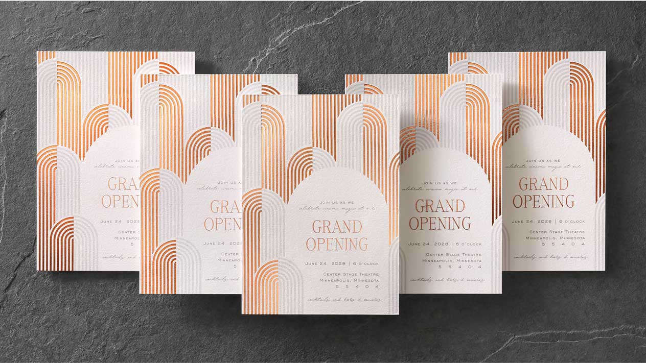 Five custom event invitations with copper foil stamping stacked in a V formation