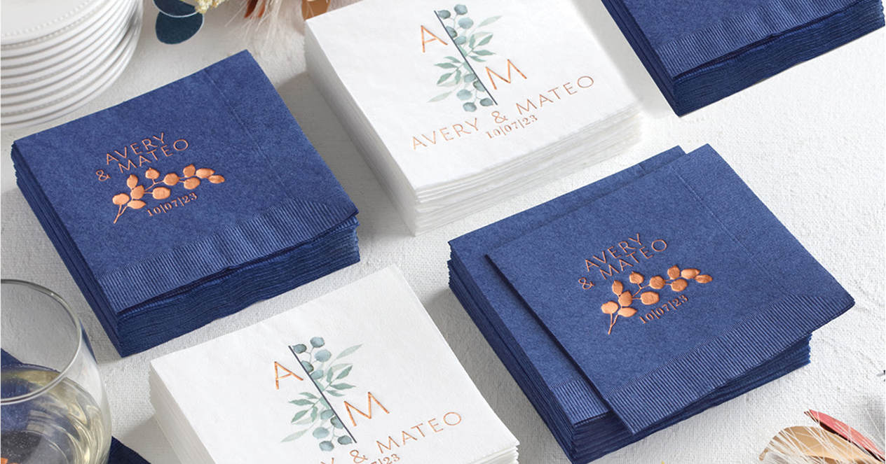 Stacks of personalized wedding napkins arranged elegantly on a wedding reception table