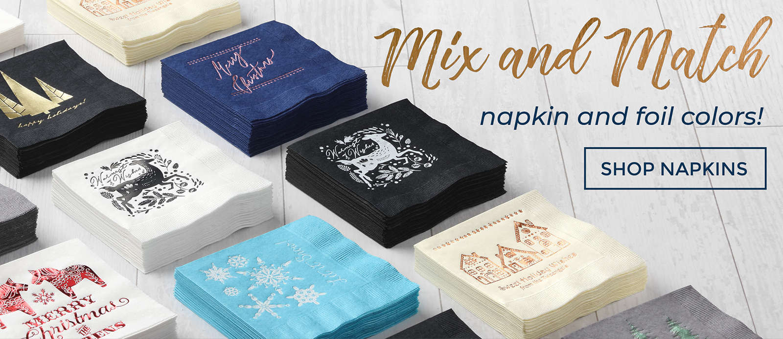 Stacks of custom printed beverage napkins featuring holiday designs in real foil displayed on a table.