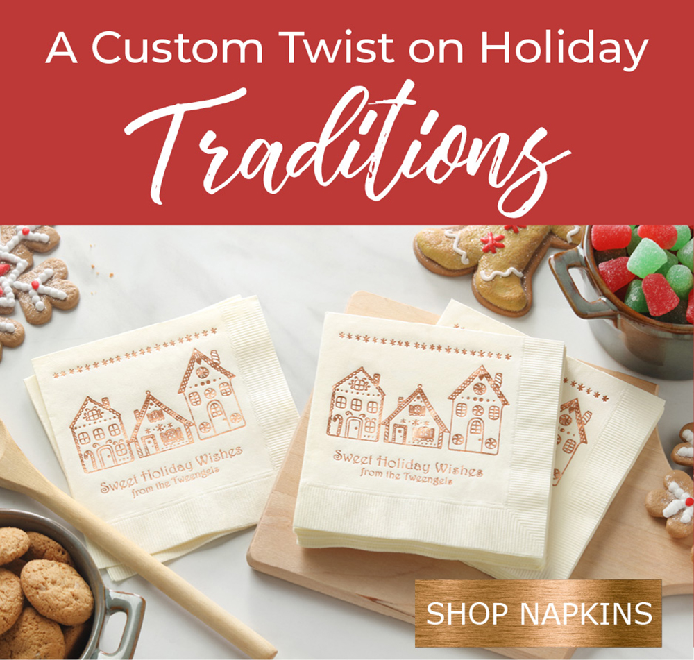 A custom print napkin is shown with gingerbread houses in copper foil and surrounded by cookies.