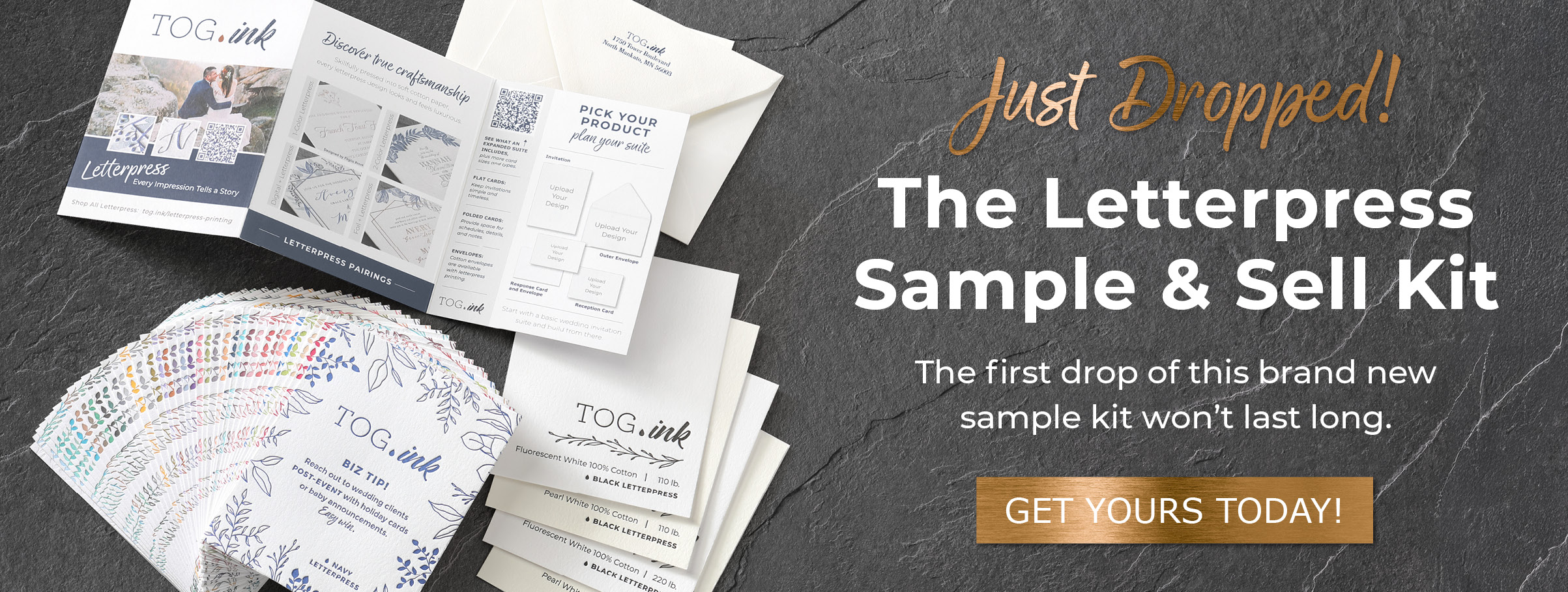 Various parts of the letterpress sample and sell kit are laid out against a slate background.