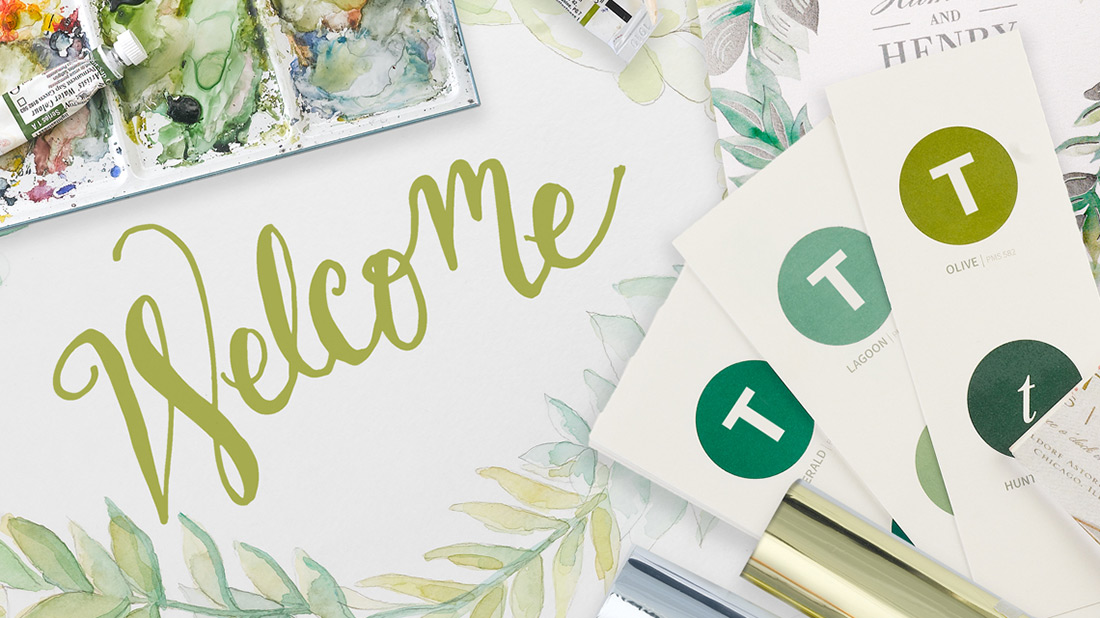 An artist's tools are shown shown with a watercolor greenery illustration and the word Welcome. 