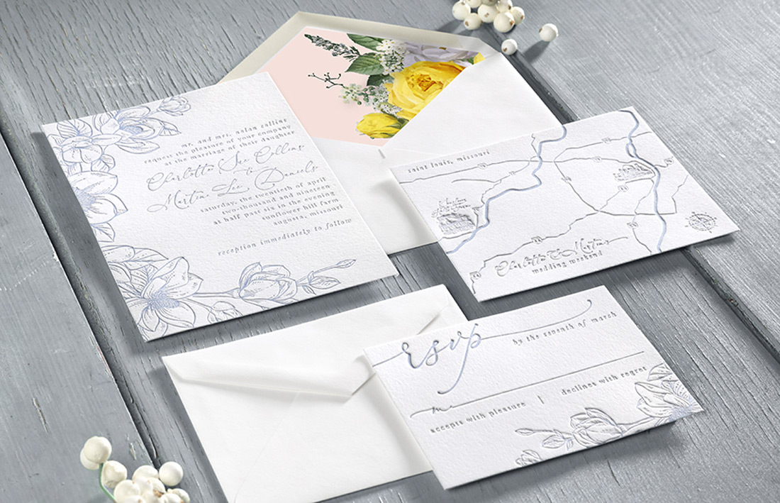 Letterpress wedding invitation suite elegantly arranged with a full color floral envelope liner. 