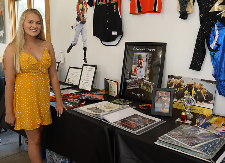 Graduation Party honors table and photo display with sports awards and team jerseys.