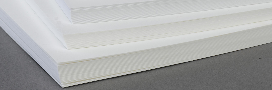 Stacks of white vellum paper. 