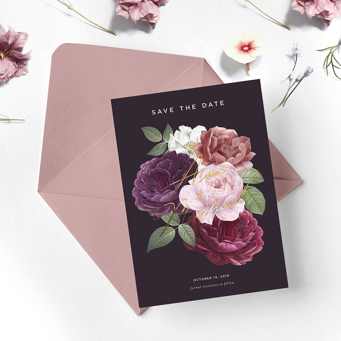 A vibrant floral illustration on a deep burgundy save the date with matching envelope. 