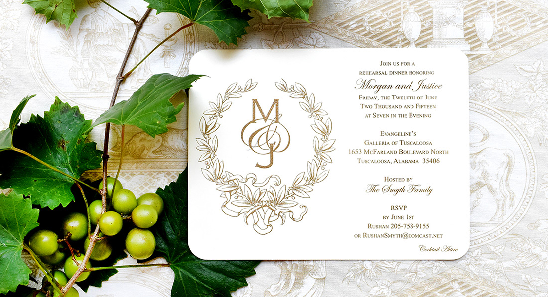 A foil stamped wedding invitation next to vibrant greenery. 