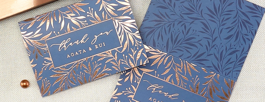 A classic blue thank you card foil stamped in gold foil greenery.