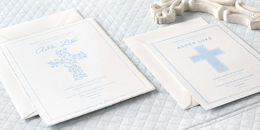 Two custom baptism invitations with light blue thermography print on a baby blue quilt.
