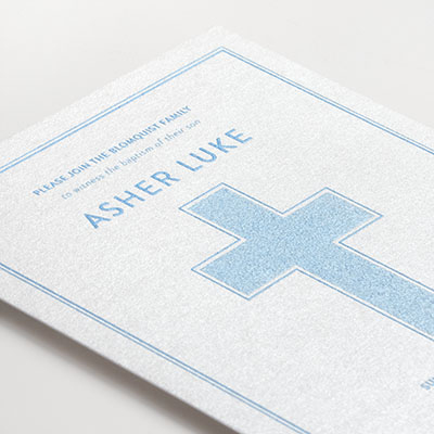 Custom Baptism invitation with light blue thermography and a bold cross design on shimmer paper. 