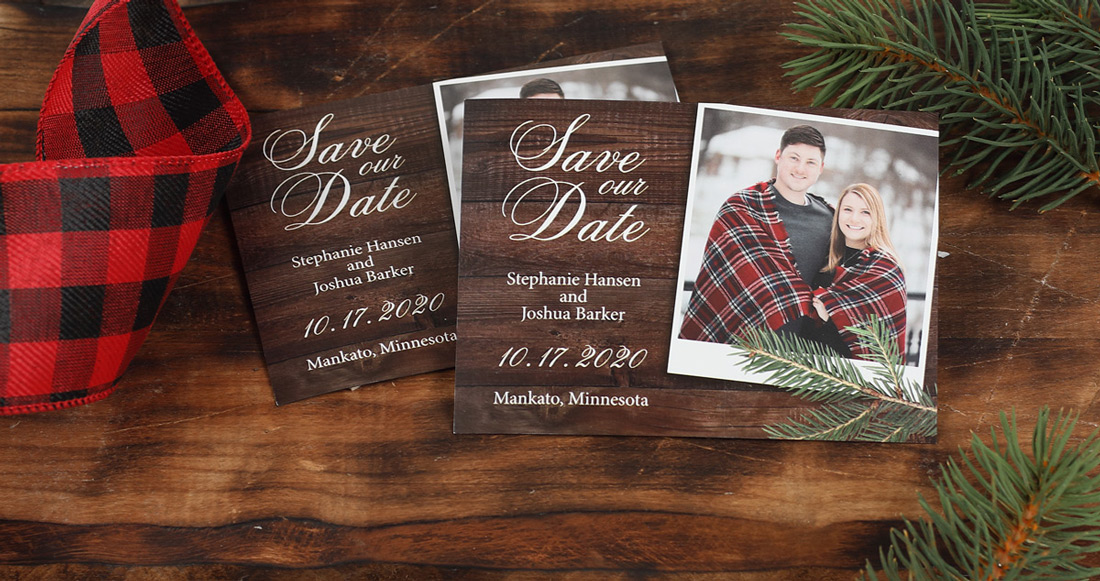 Digitally printed photo save the dates on a barn wood background with a buffalo plaid accent ribbon.
