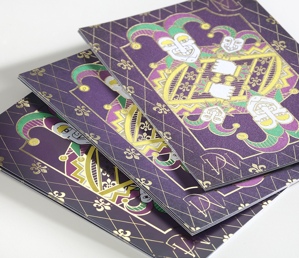 The finished mardi gras invitation with joker design and gold foil accents on all three paper options. 