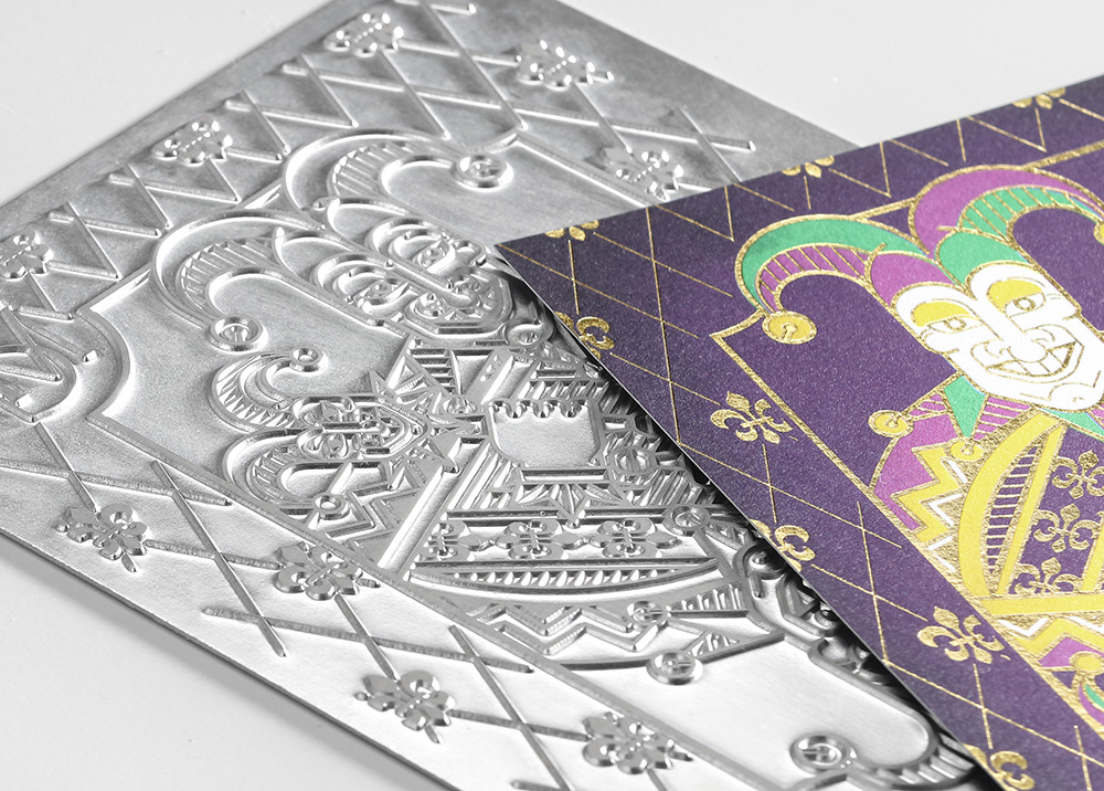 The metal die is shown with the mardi gras invitation to showcase how foil stamping occurs. 