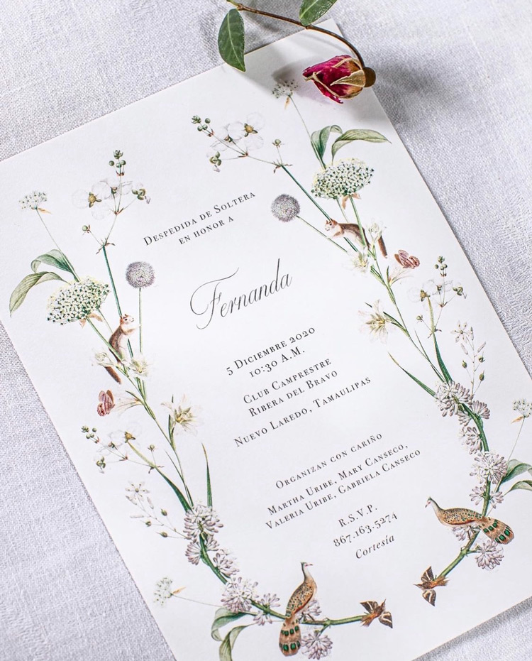 Custom Spanish invitation with full-color floral design on a fabric backdrop. 
