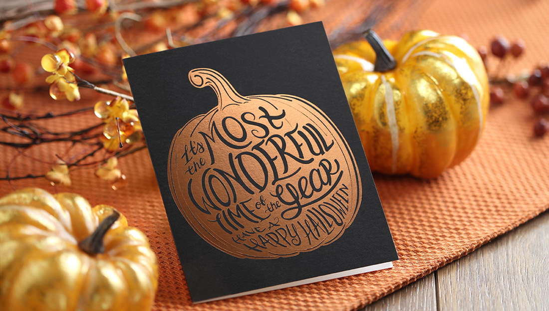A pumpkin stamped in orange foil feature "the most wonderful time of the year" in script font. 