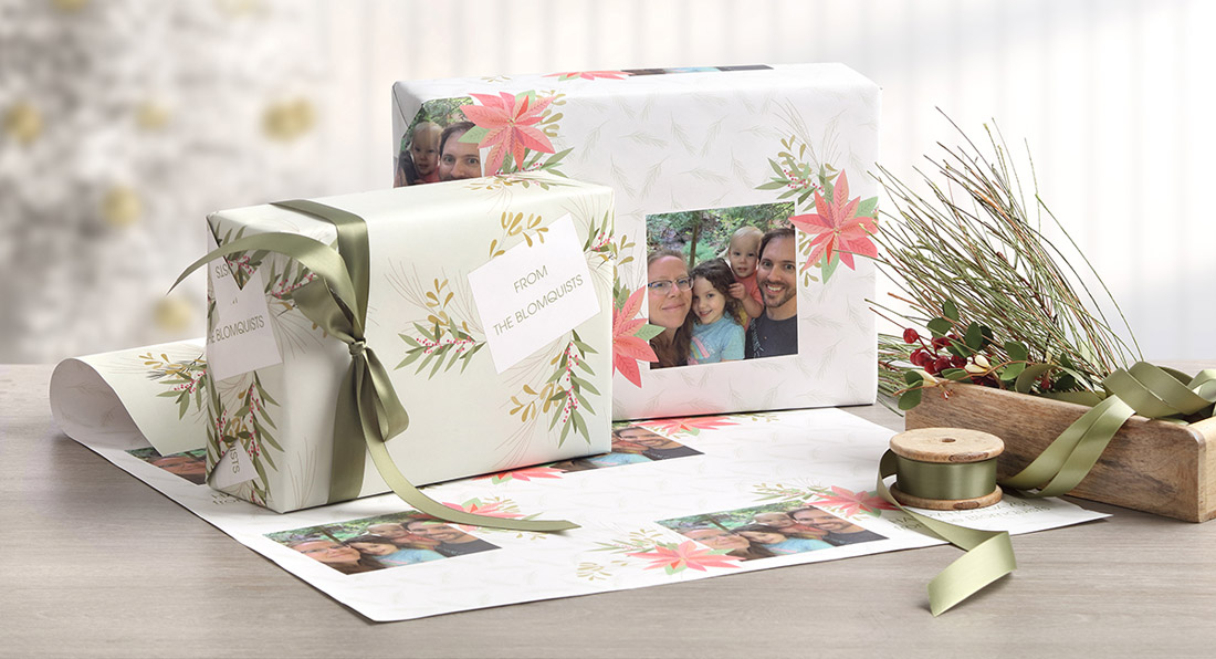 Gifts are shown wrapped in personalized wrapping featuring pink poinsettias and a family photo. 