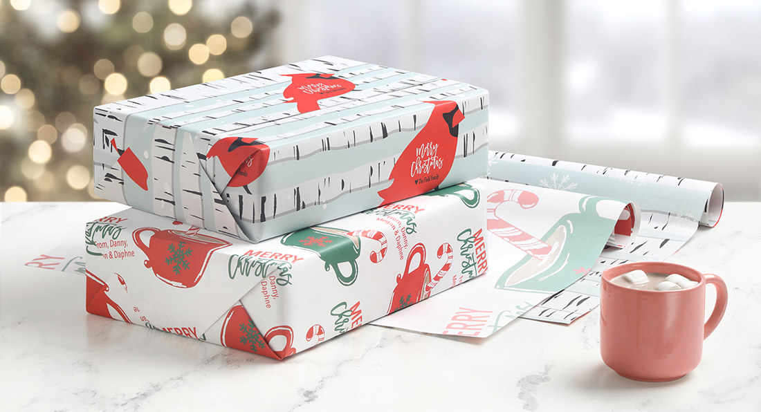 Two gifts are shown wrapped in personalized wrapping paper featuring cardinals on one and coffee cups on the other. 