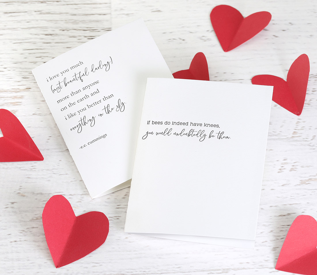 A letterpress greeting card with an inspirational mesage and paper heart decorations around it.