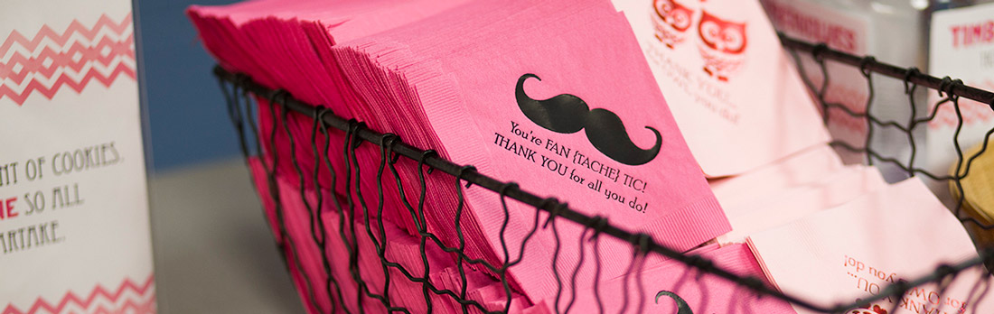 Bright pink beverage napkin with a black foil mustache and light pink napkin with red foil owls.