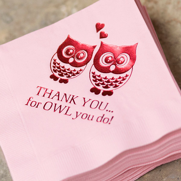 A bright pink napkin is stamped with red foil owls and "Thank you for owl you do!"