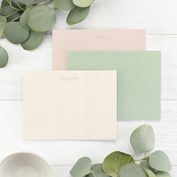 Three envelops in muted colors with "thank you" stamped in gold foil. 