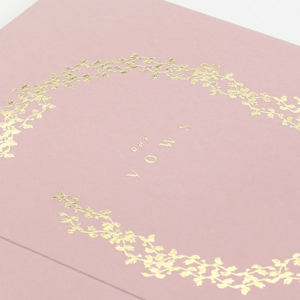 Vow cards with gold foil stamping on pink folding cards. 