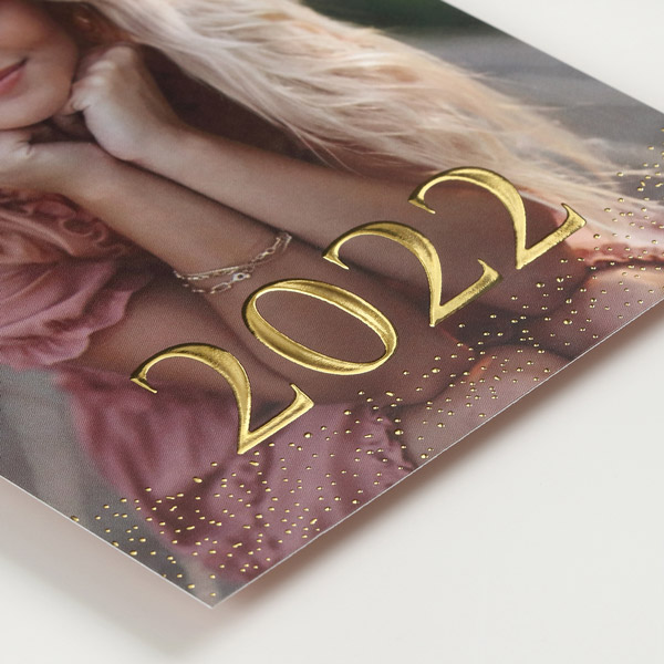 A closeup of enhanced gold foil on a photo graduation card. 