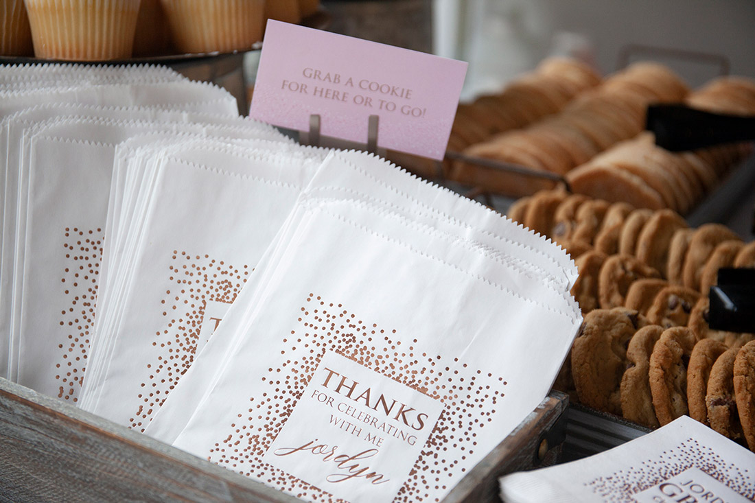 Foil-stamped treat bags are shown next to a tray of cookies.