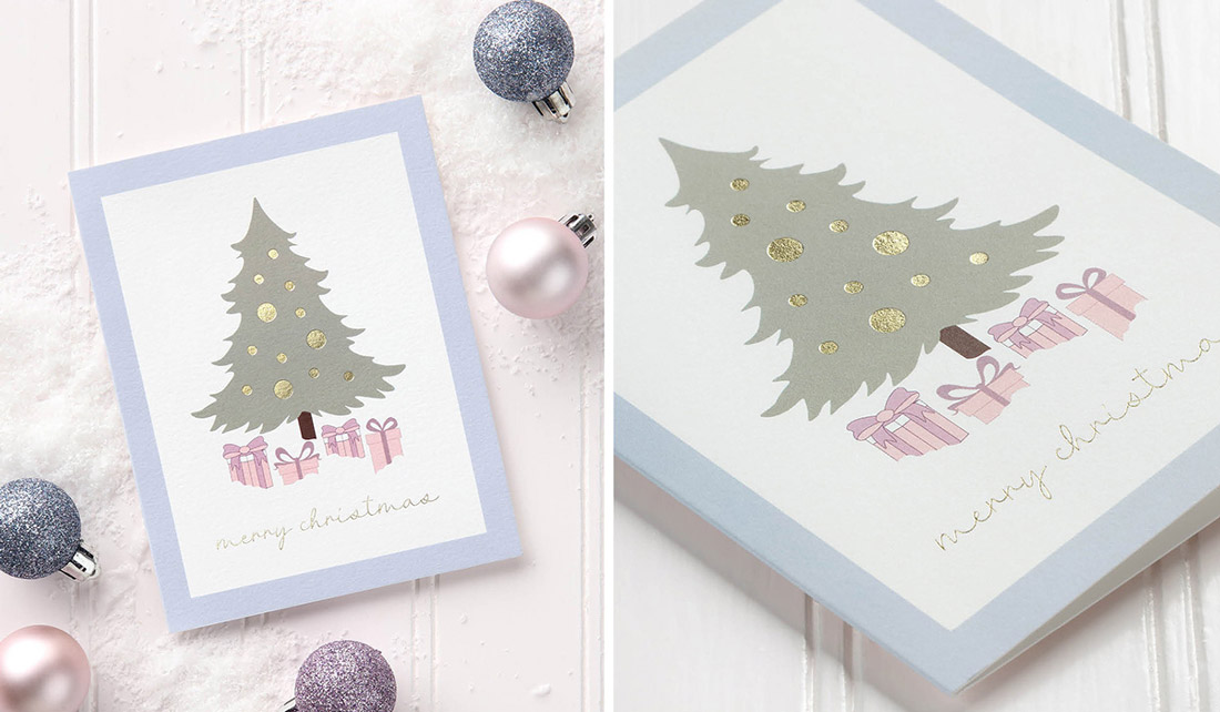 A custom holiday card with Christmas tree and gifts in digital print with fold foil accents. 