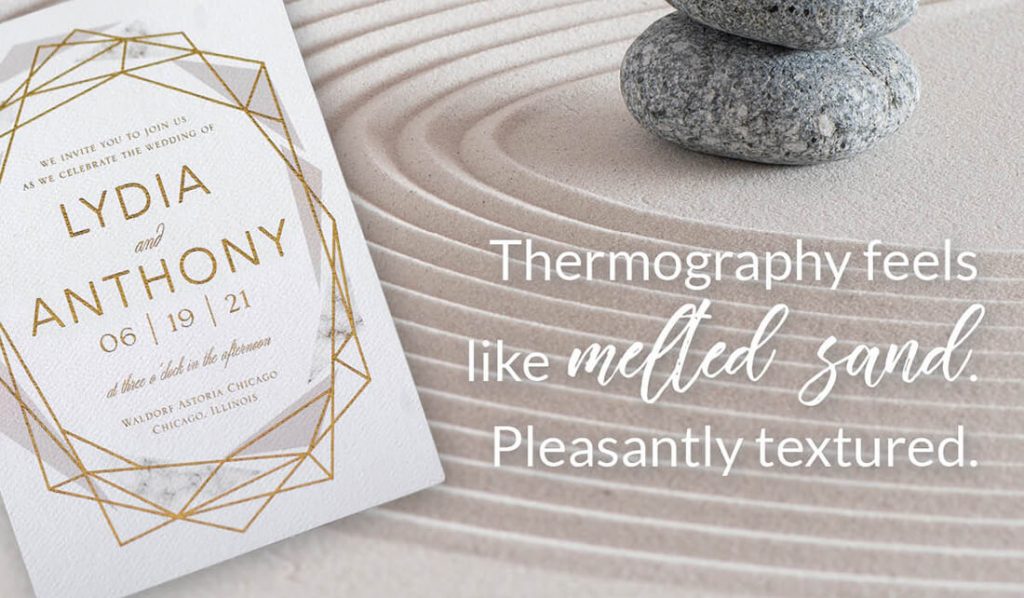 A thermography printed wedding invitation is shown with a zen sand garden in the background to symbolize that thermography feels like melted sand. 