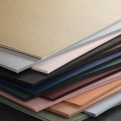 A stack of flat cards in new paper colors like pine, terracotta, arctic blue and more.