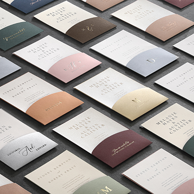 Custom printed invitation pockets laid out in a variety of beautiful colors.